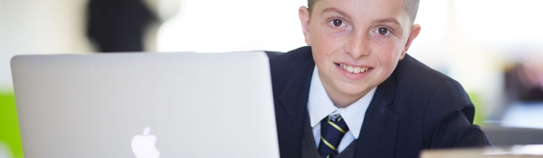 Student boy using a macbook